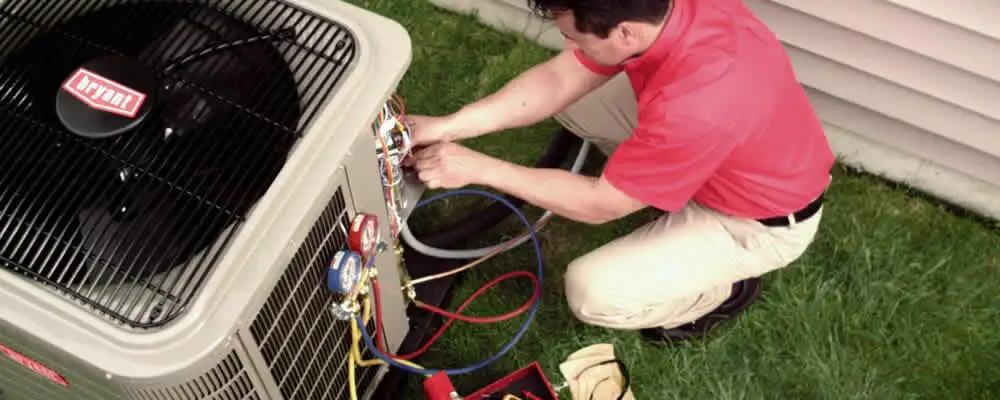 HVAC technician servicing an outdoor air conditioner unit in Redding, CA